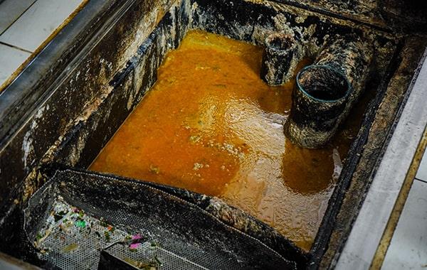 delaying grease trap cleaning can result in clogs, foul odors, and even sewage backups